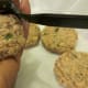 Forming salmon patty is done with palm and fork.