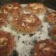 Patties browning in hot skillet.