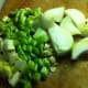 Chop the celery ribs, onion, and garlic cloves.