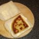 Fried tattie scone is laid on one slice of bread