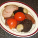 Bacon, tomato and mushrooms are added to the plate