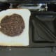 Cooled haggis slice is laid on first slice of bread