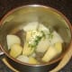 Butter and chives added to drained potato and trunip