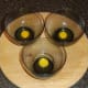 Quail eggs broken in to glass bowls
