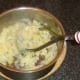 Mashing potato and turnip to make clapshot