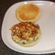 Spicy chicken burger is laid on bun.