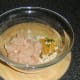 Combining curried chicken burger ingredients.