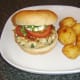 Spicy chicken burger and roast potatoes is ready to eat.
