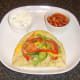 Mixed bell peppers are arranged as a bed of bottom half of naan bread.