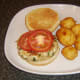 Tomato slices are laid on spicy chicken burger.