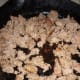 Brown 1 pound of breakfast sausage in a skillet. Do NOT drain the drippings. You'll need it for the next step.
