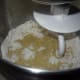 Add the egg yolks and turn the mixer on low. Mix the dry ingredients together and slowly add them to the milk/butter/yeast in the bowl.