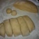 Once it has risen, divide the dough in half. Then divide each half into six pieces then divide each of those pieces into three equal pieces. You should have 36 pieces. Form all of the pieces into balls.