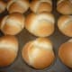 Preheat the oven to 350 degrees and bake for 20 minutes. The rolls will be dark brown on the top when done. Pull them out of the oven and brush with melted butter.