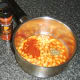 Smoked paprika and basil are added to baked beans in tomato sauce