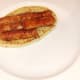 Sausages are lifted on to naan bread