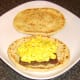 Turmeric spiced egg is spooned on to curried Lorne sausage