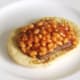 Spicy baked beans are spooned on to Lorne sausage