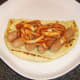 Indian spiced onions are spooned on to pork sausages