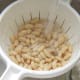 Cannellini beans are washed through a colander