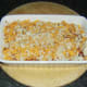 Cheese and breadcrumbs are scattered over pasta and plaice