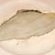 Skin side of plaice fillet is patted in seasoned flour