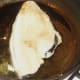 Plaice fillet is laid in pan skin side down
