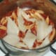 Chunks of plaice fillet are added to pasta and tomato sauce
