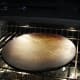 Pampered Chef pizza stone in preheated oven