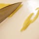 Knife cutting lemon zest.
