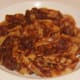 Tagliatelle in beef and red wine sauce is plated