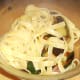 Tagliatelle is added to roasted vegetables
