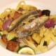 Sardine fillets are laid on tagliatelle and vegetables