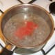 Canned tomatoes are added to beef and stock