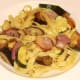 Tagliatelle and vegetables are plated