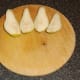 Pips and core are cut from pear quarters