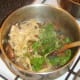 Parsley is stirred through pasta before service