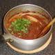 Chopped coriander is stirred in to venison curry
