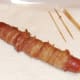 Cocktail sticks removed from bacon wrapped dog