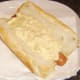 Mac and cheese spooned on to hot dog