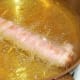 Deep frying bacon dog