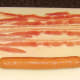 Preparing to assemble bacon dog