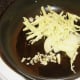 Sliced and chopped cabbage, onion and garlic is added to frying pan