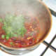 Fresh coriander is added to bean chilli
