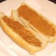 Peanut butter is spread on both sides of cut sub roll