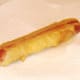 Deep fried, battered hot dog is drained on kitchen paper