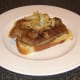 Onions and mushrooms are carefully spooned on to ox liver.