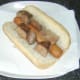 Sliced liver is laid on top of hot dog.