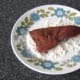 Liver is patted in seasoned flour.