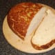 Thick slice of bread is cut for toasting.